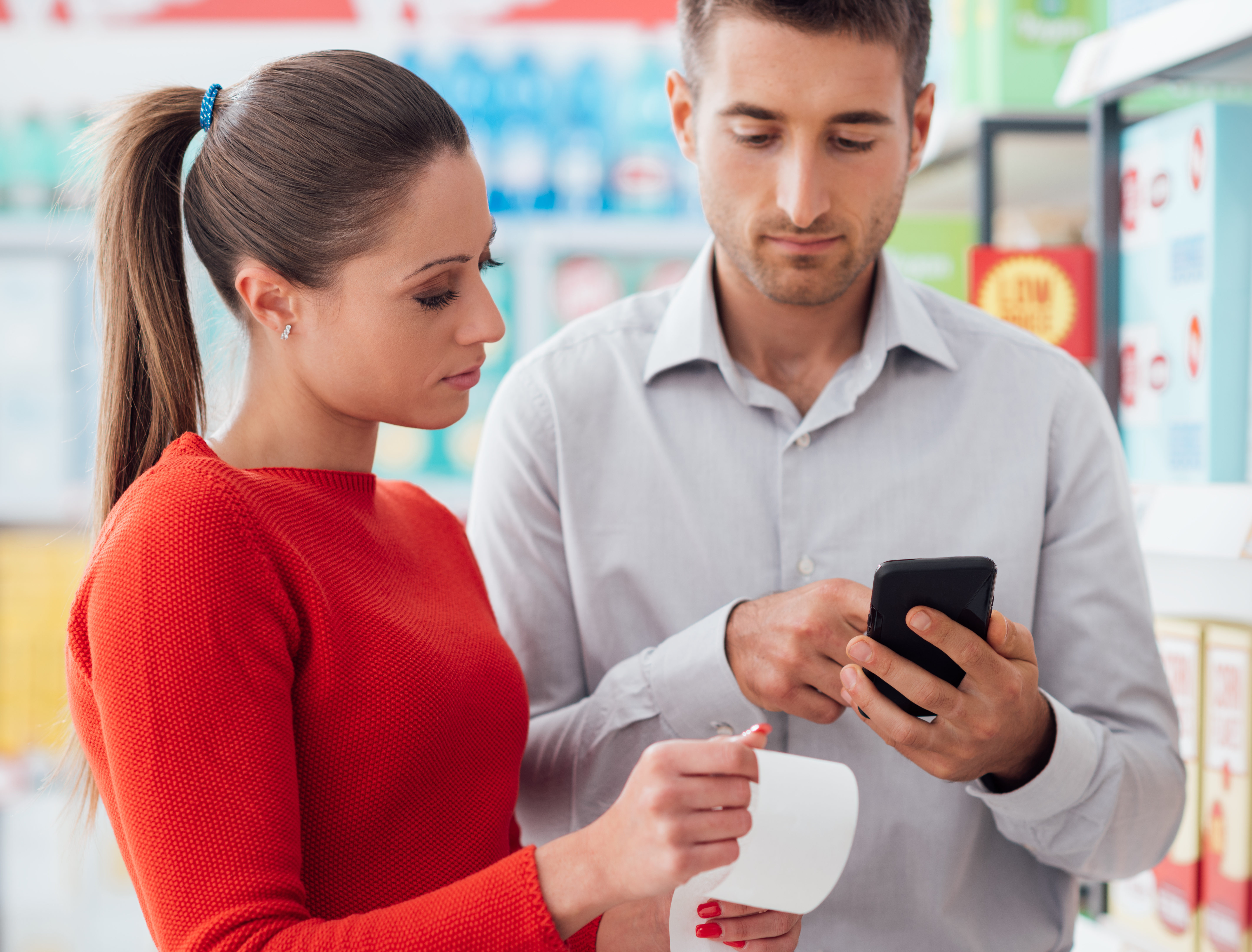 Couple shopping and checking a receipt