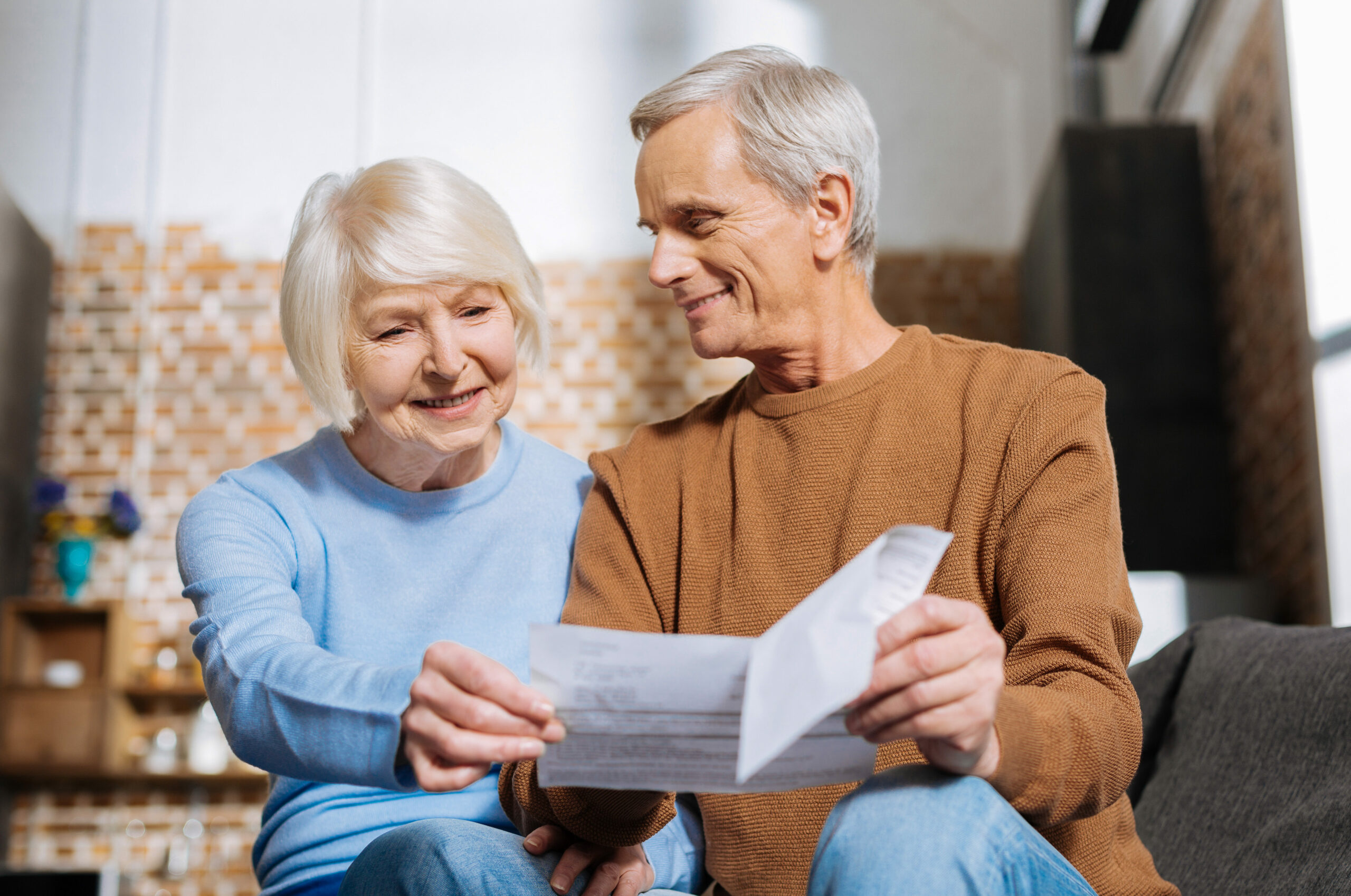 Joyful nice woman looking at the piece of paper