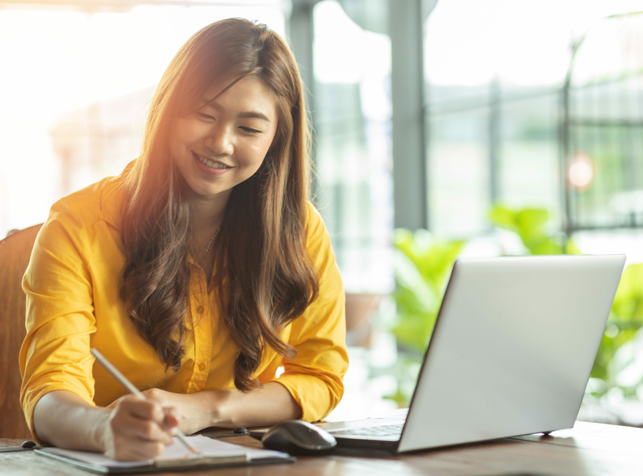 Beautiful Attractive Asian woman working with laptop smile and w