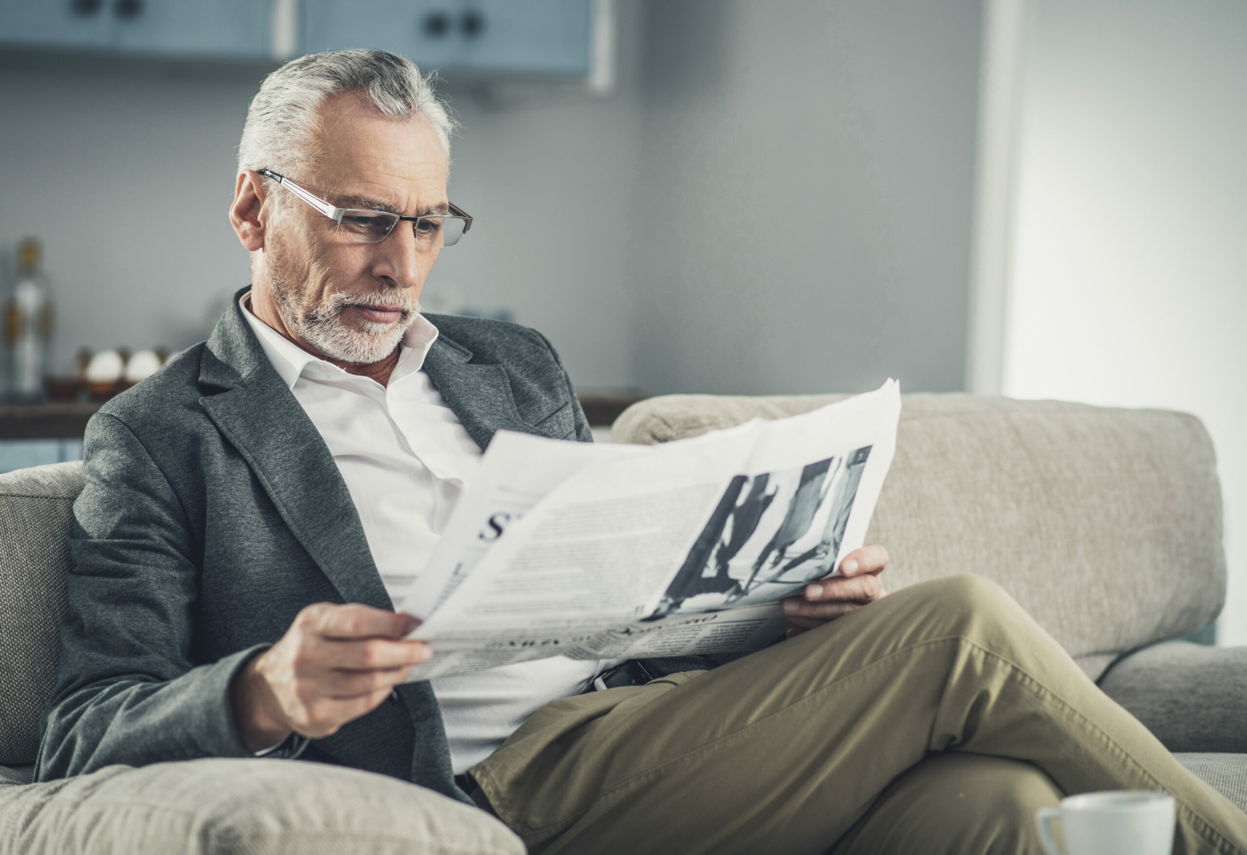 Intelligent businessman reading daily newspaper